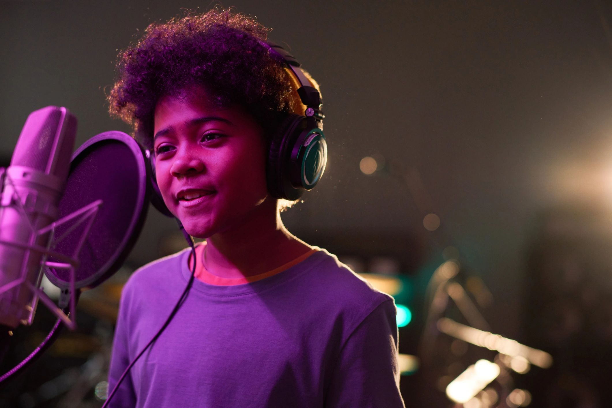 Teen singing in a recording studio lesson